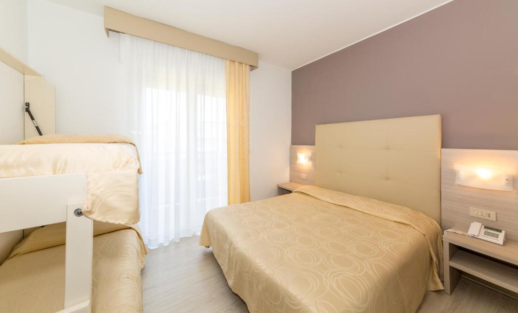 Postel nebo postele na pokoji v ubytování Hotel Torino