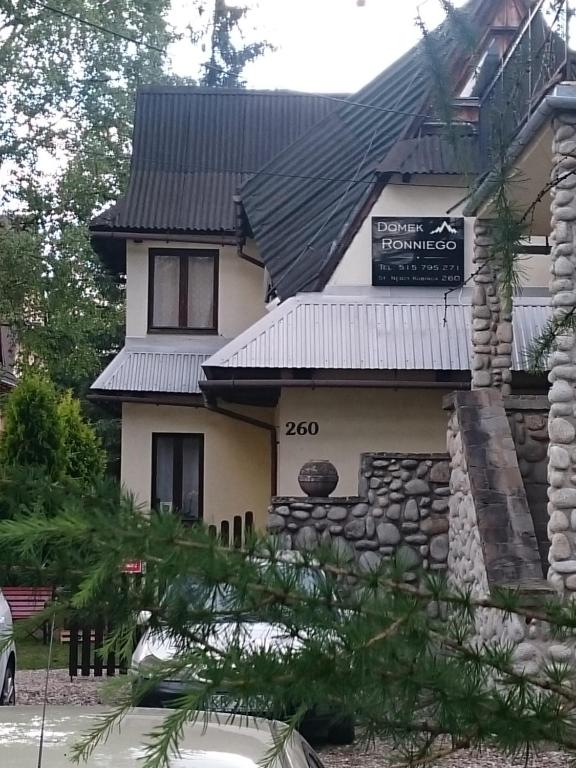 a house with a sign on top of it at Domek Iris in Kościelisko
