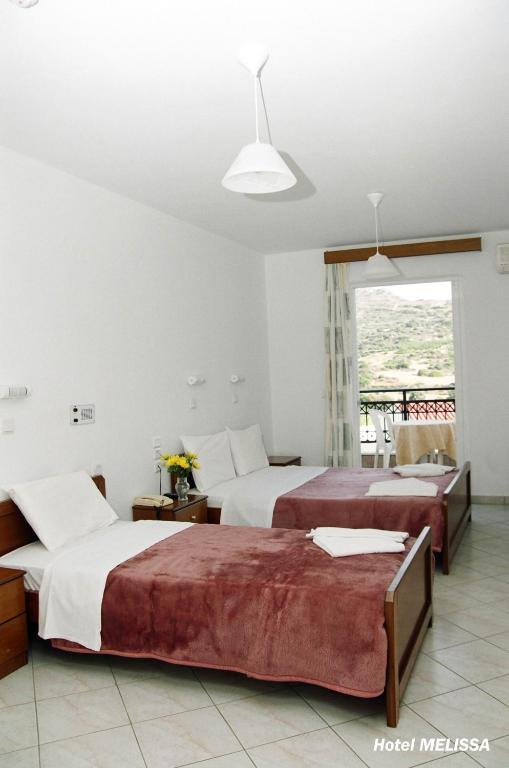 Postel nebo postele na pokoji v ubytování Melissa Hotel
