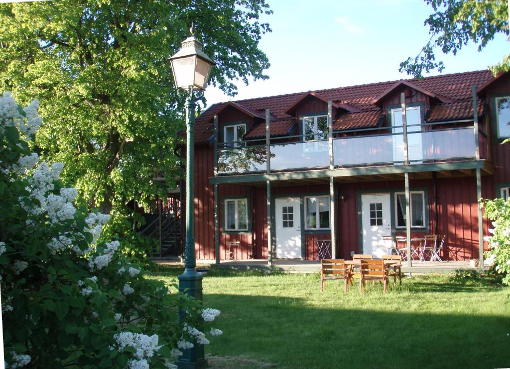 a house with a street light in front of it at Freja Vandrarhem in Vreta Kloster