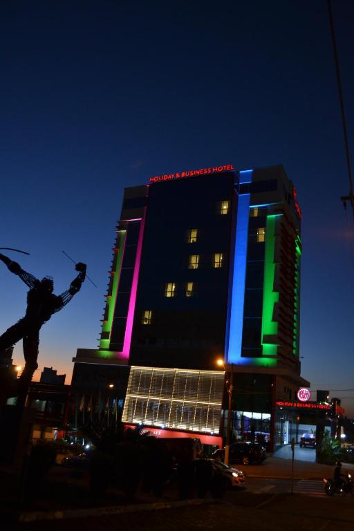 a large building with lights on it at night at Holiday & Business Hotel - Em frente ao Centro de Eventos e Arena Conda in Chapecó