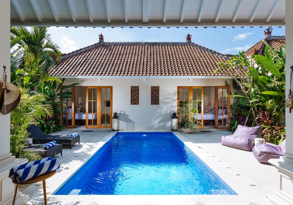 a swimming pool in the backyard of a house at Villa Alliv in Seminyak