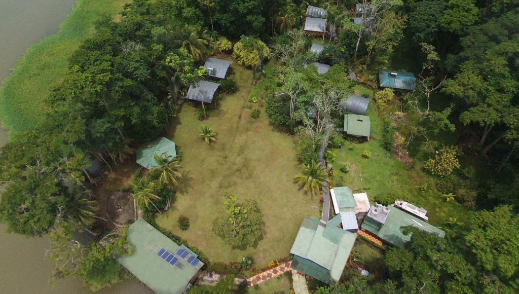 an aerial view of an island with houses and trees at Lirio Lodge in Barra de Pacuare