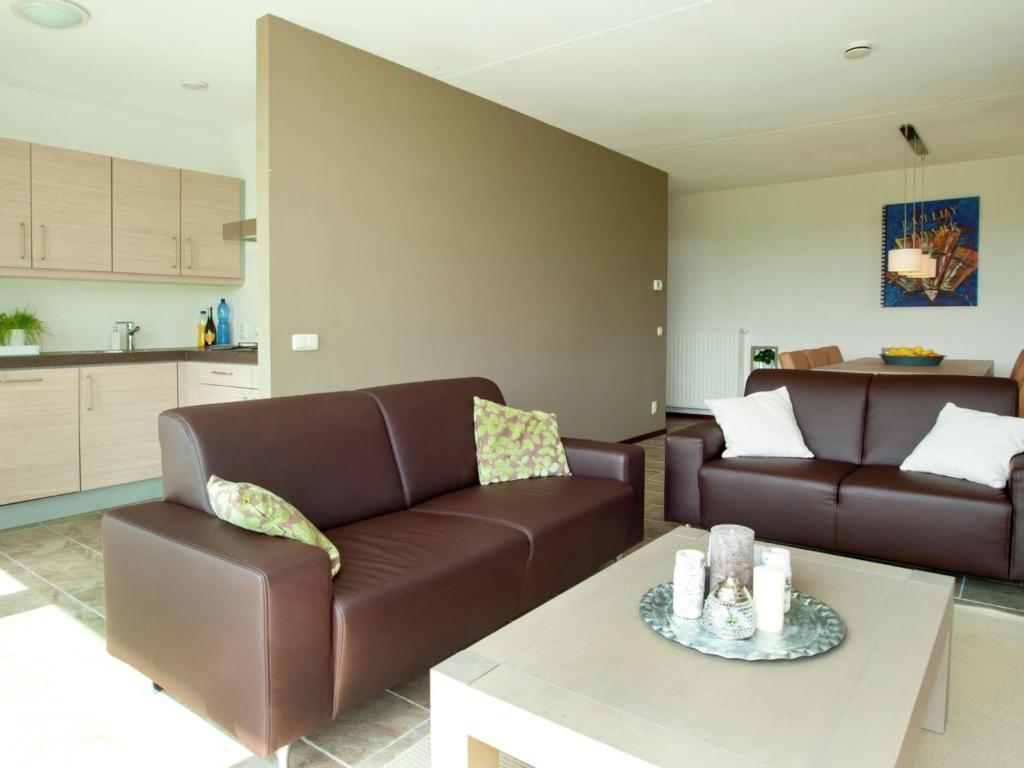 a living room with a couch and a table at Tail-Wagging Lake Escape in Heel