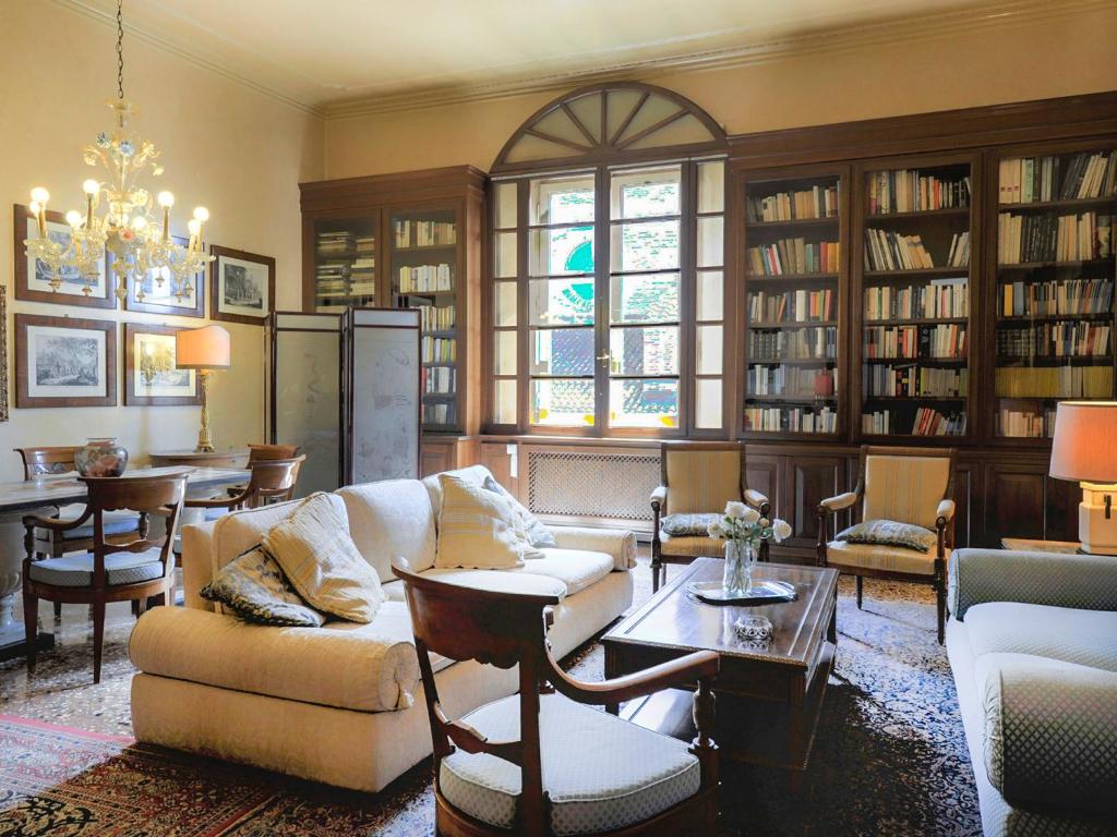 a living room with a couch and chairs and a table at UR-NEST Strada Maggiore in Bologna