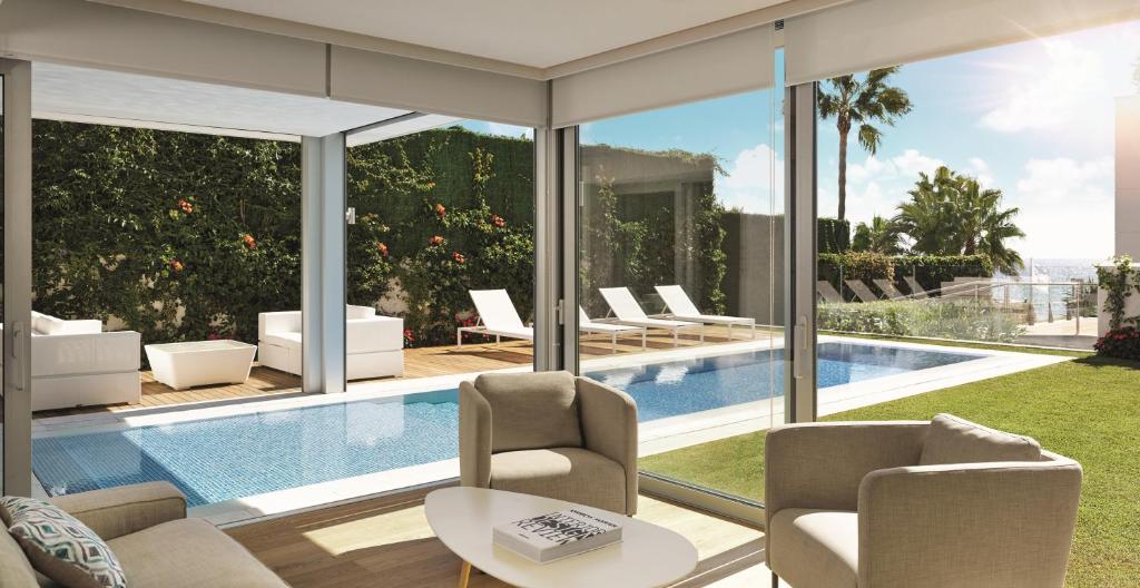 a living room with a view of a pool at Puente Romano Marbella in Marbella