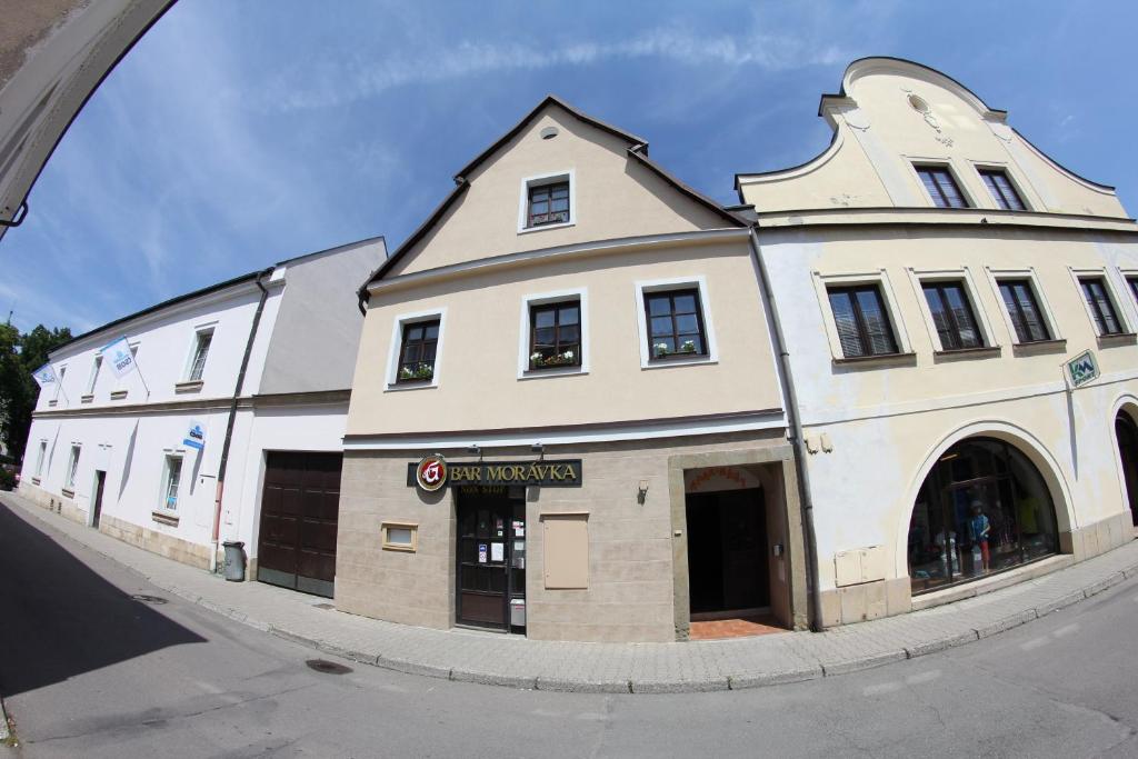 a large white building on the side of a street at Apartmány Morávka in Rychnov nad Kněžnou