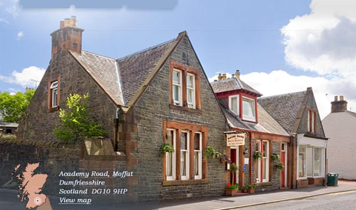 an old stone building on a city street at Hazel Bank Bed& Breakfast in Moffat