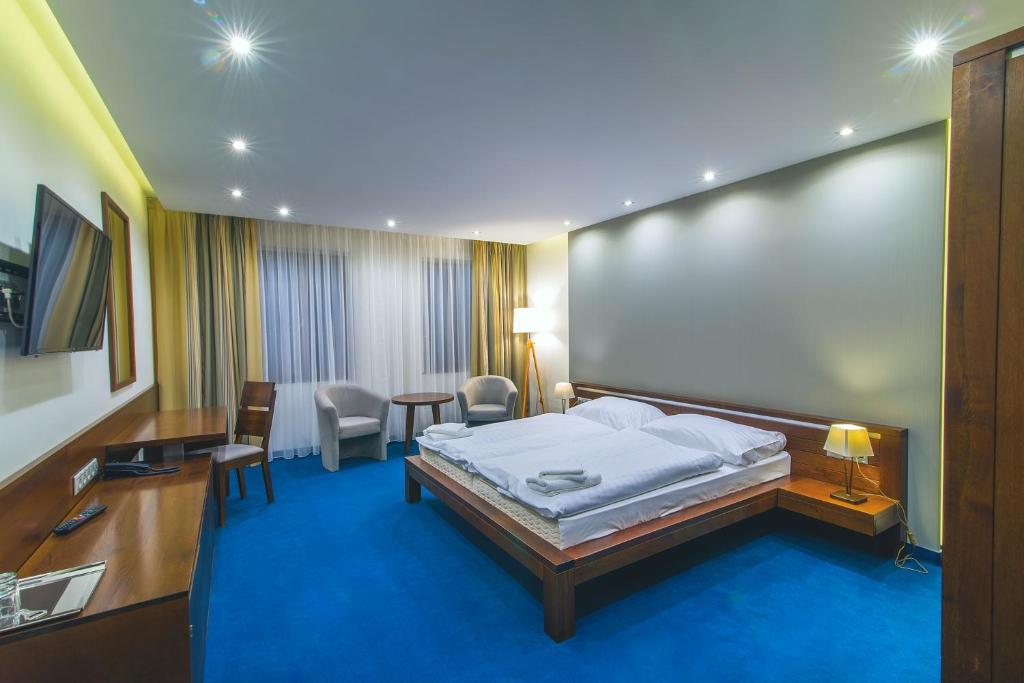 Postel nebo postele na pokoji v ubytování Hotel Arkada