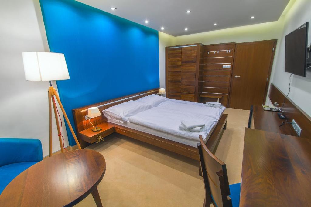 Postel nebo postele na pokoji v ubytování Hotel Arkada
