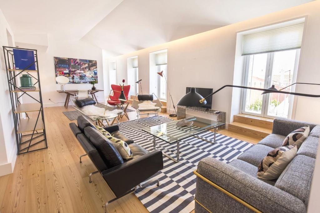 a living room with two couches and a table at LovelyStay - Luxury Oasis in Bairro Alto in Lisbon