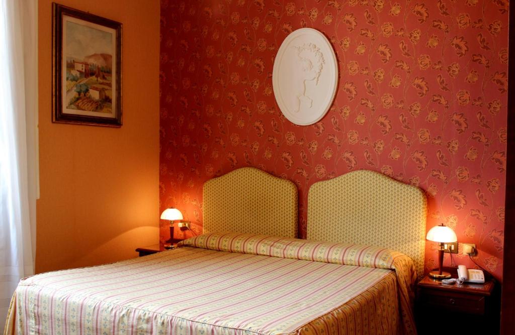 Postel nebo postele na pokoji v ubytování Hotel Beatrice