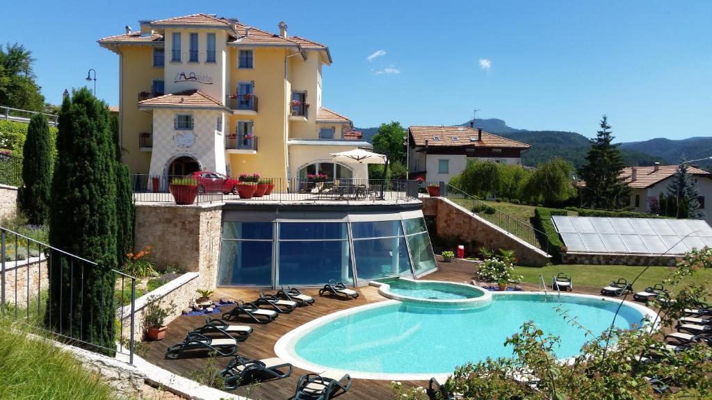 a large house with a swimming pool in front of it at La Quiete Resort in Romeno