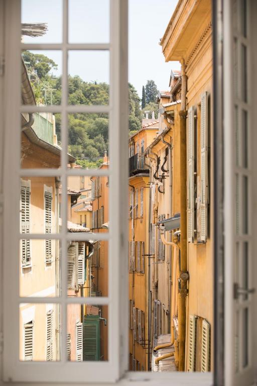 a view out of a window of a city at Palais Saleya Boutique Hôtel in Nice