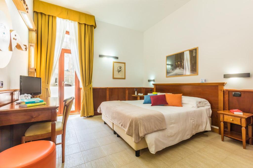Postel nebo postele na pokoji v ubytování Hotel Duomo