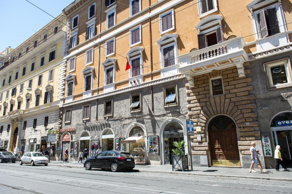 a building on a city street with cars parked in front at Ottaviano Exclusive Maison in Rome