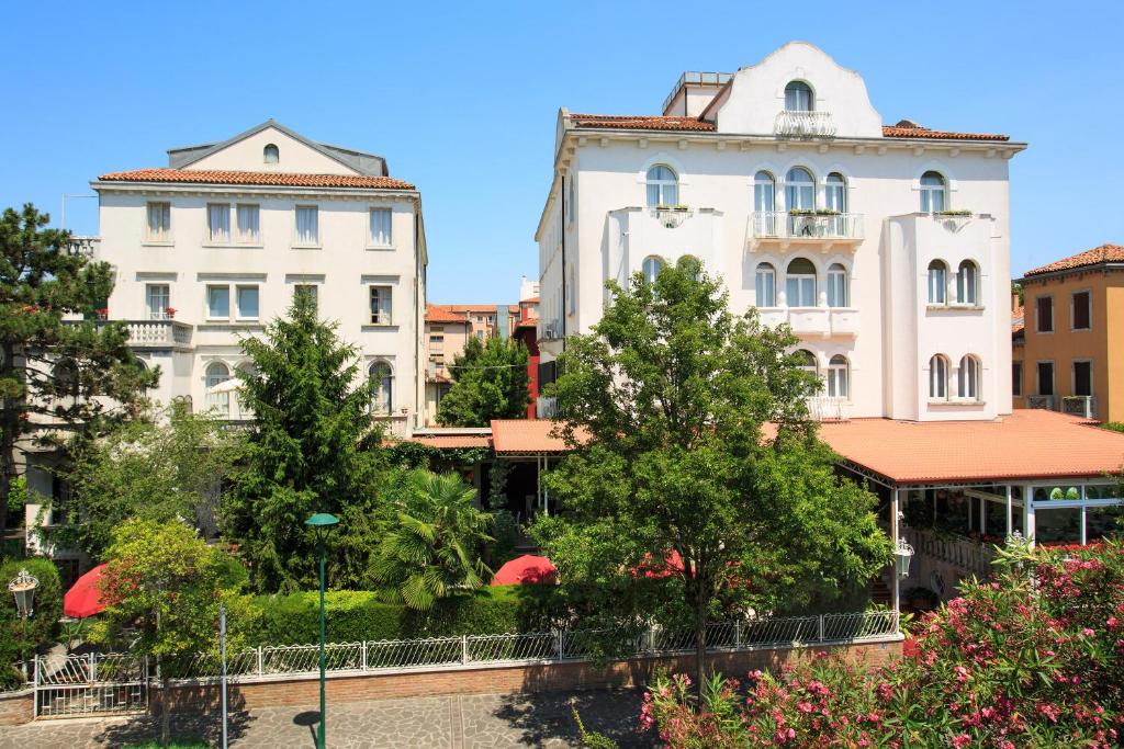 a group of buildings in a city with trees at Hotel Biasutti in Venice-Lido