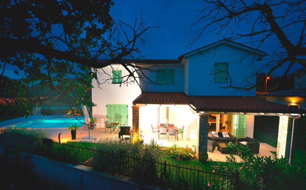 a house with a swimming pool at night at Villa Barbara in Selina