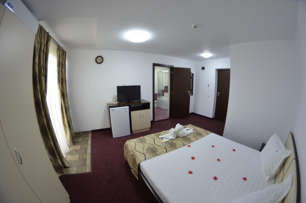 Postel nebo postele na pokoji v ubytování Razvan Holiday