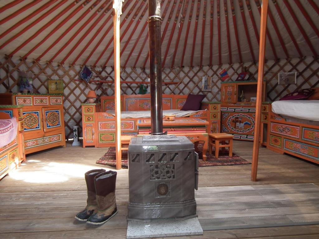 a room with a wood stove in a yurt at yourte d'hotes in Mailley-et-Chazelot