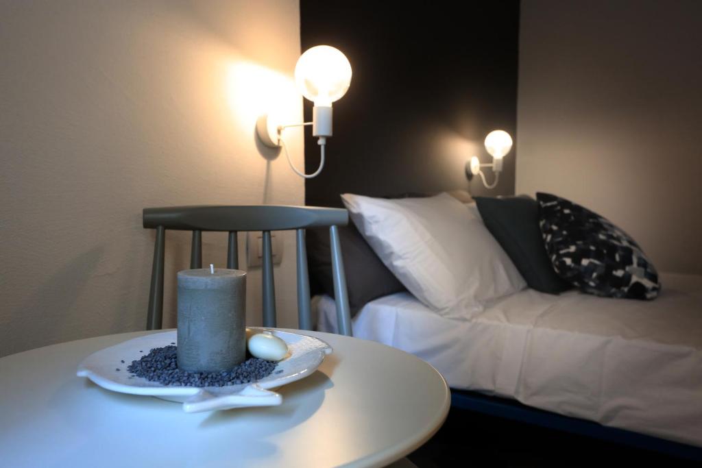 a room with a bed and a table with a candle at FONTEblu B&B in Polignano a Mare