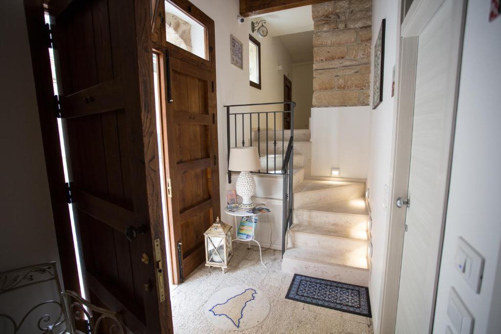 a hallway with a door and stairs in a house at B&B Cinisi Vacanze 2.0 in Cinisi