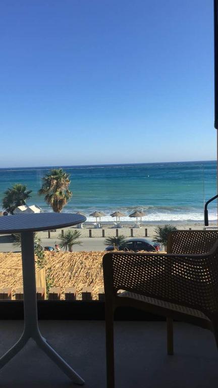 a view of a beach with a table and chairs at H Boutique Peña Parda in La Herradura