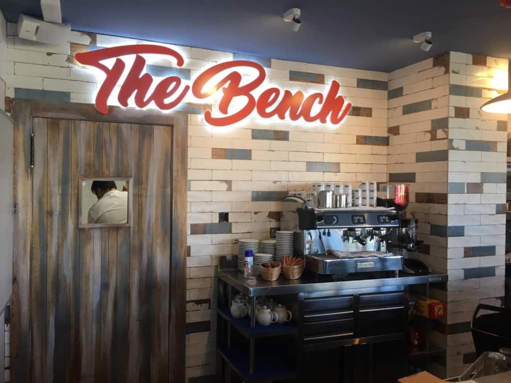 a restaurant with a sign that reads the bench at H Boutique Peña Parda in La Herradura