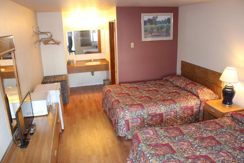 Postel nebo postele na pokoji v ubytování Silver Sands Motel