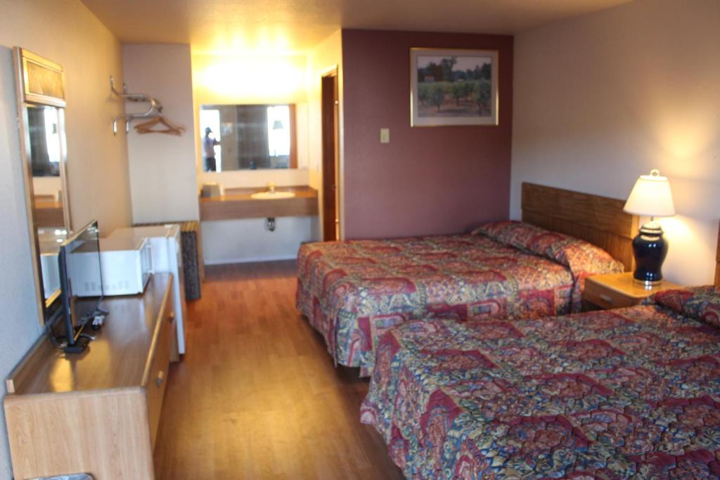 Postel nebo postele na pokoji v ubytování Silver Sands Motel