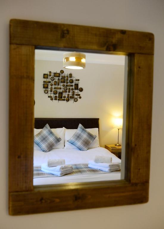 Postel nebo postele na pokoji v ubytování Birchbrae Highland Lodges