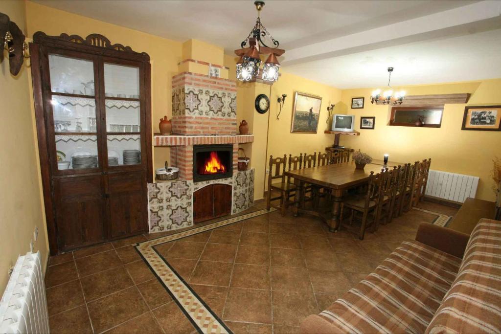 a living room with a table and a fireplace at Casa Rural Calderon de Medina I y II in Siete Iglesias de Trabancos
