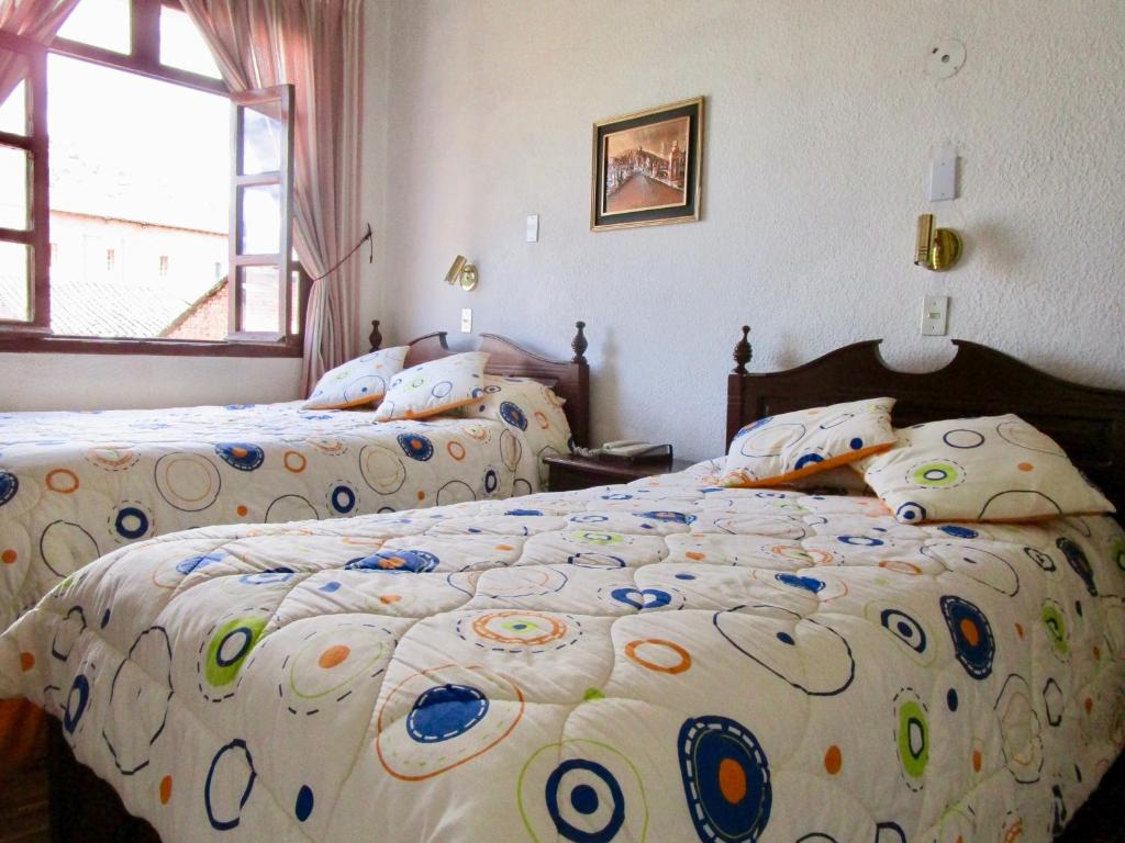 Postel nebo postele na pokoji v ubytování Hotel Huasi Continental