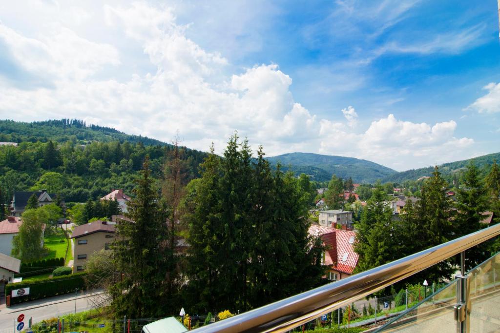 a view of a city with trees and mountains at Tęczowe Wzgórze Apartament Oaza in Wisła