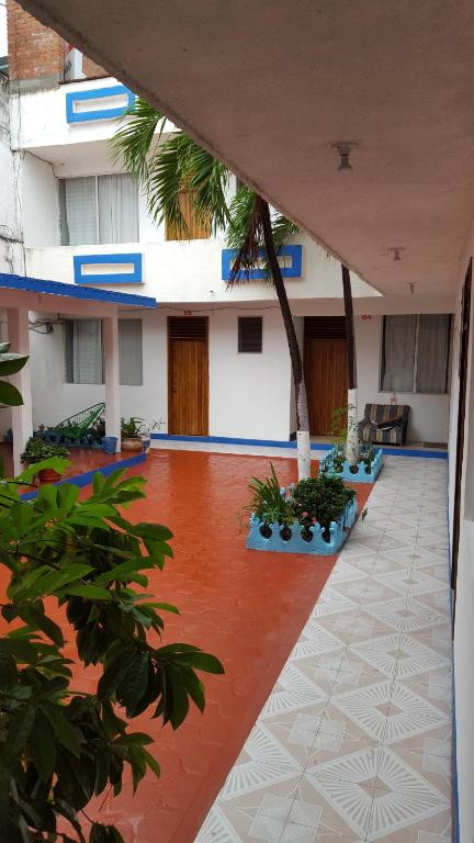 an outside view of a building with a courtyard at Hotel Carruiz in Puerto Escondido