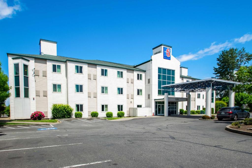 a large white building with a parking lot at Motel 6-Portland, OR - North in Portland