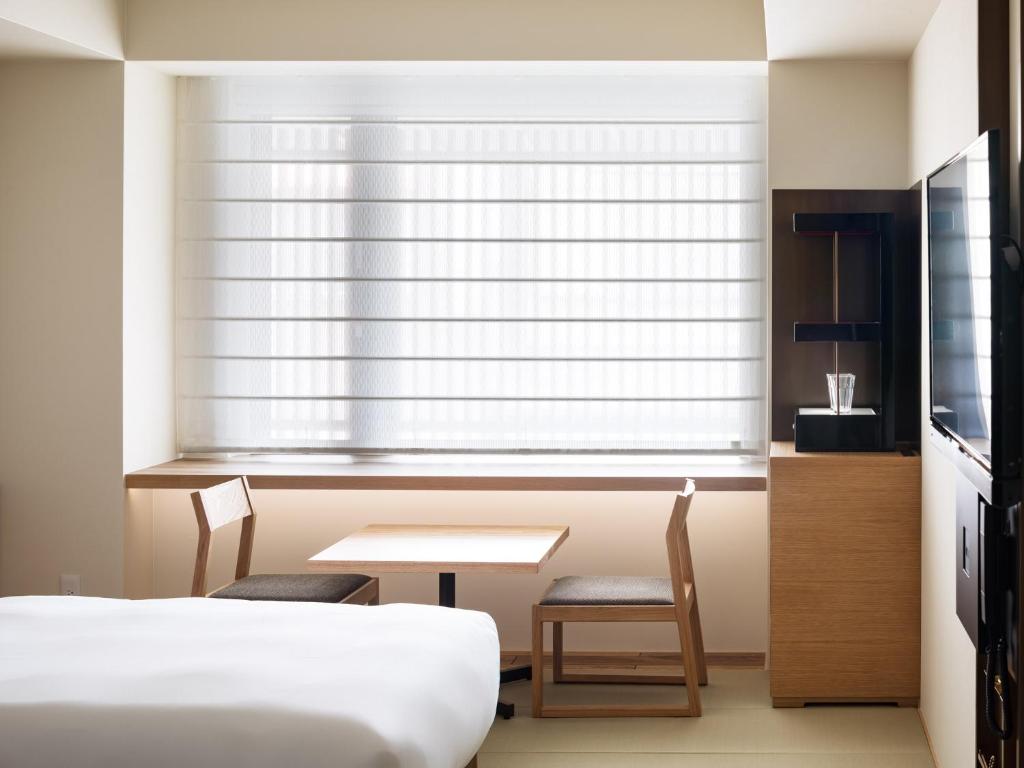 Postel nebo postele na pokoji v ubytování Kyoto Granbell Hotel