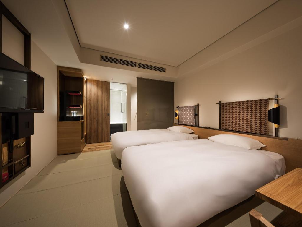 Postel nebo postele na pokoji v ubytování Kyoto Granbell Hotel