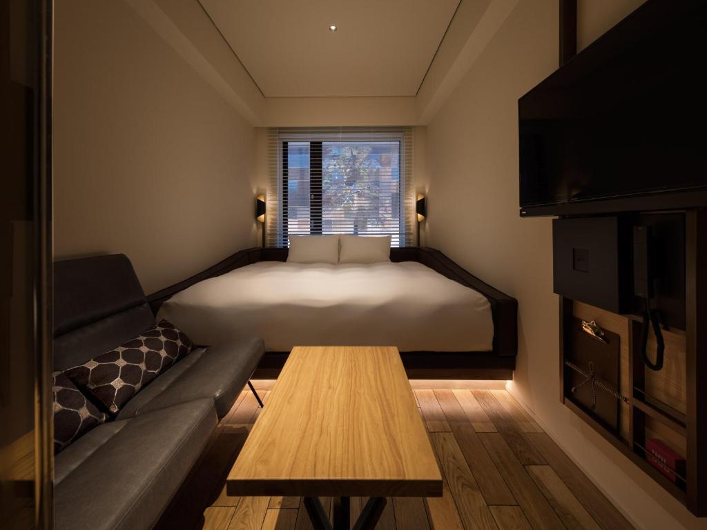 Postel nebo postele na pokoji v ubytování Kyoto Granbell Hotel