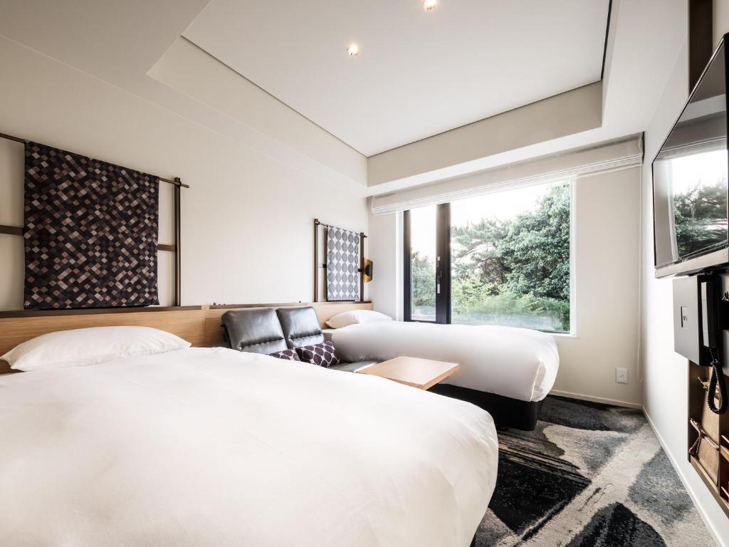 Postel nebo postele na pokoji v ubytování Kyoto Granbell Hotel