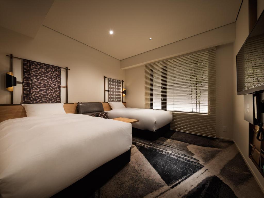 Postel nebo postele na pokoji v ubytování Kyoto Granbell Hotel