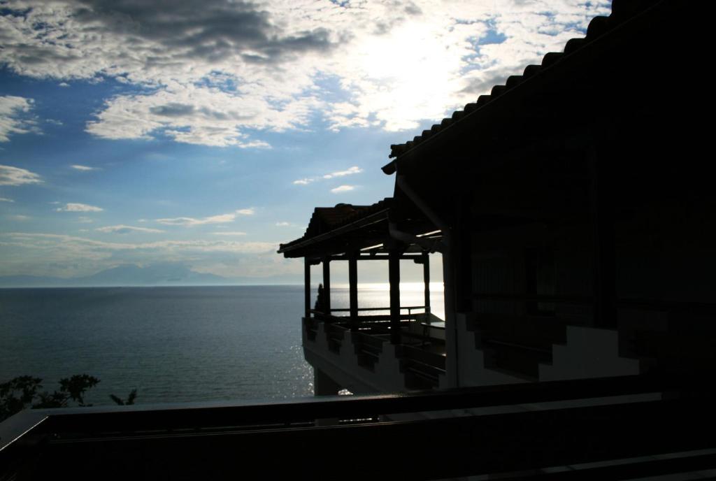 a view of the ocean from a building at Thea Suites Potidea in Nea Potidaea