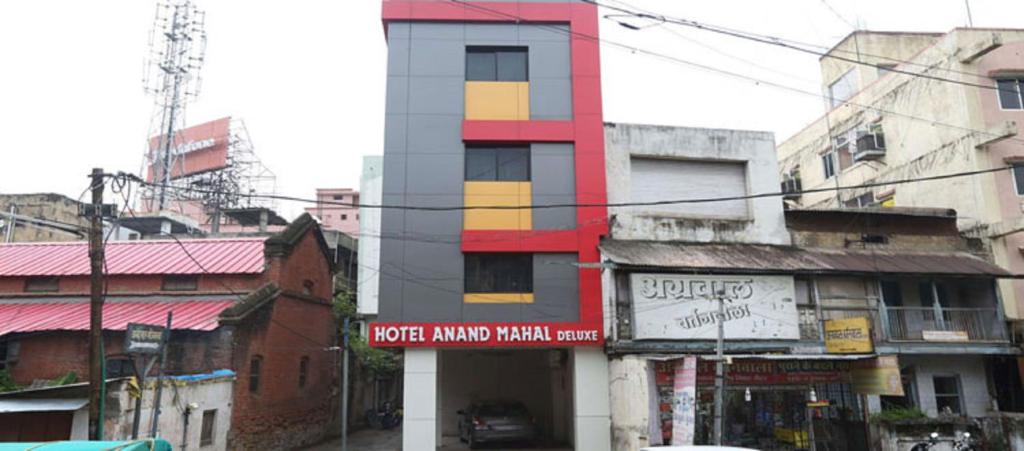 a tall building in a city with buildings at Anand Mahal Hotel in Nagpur