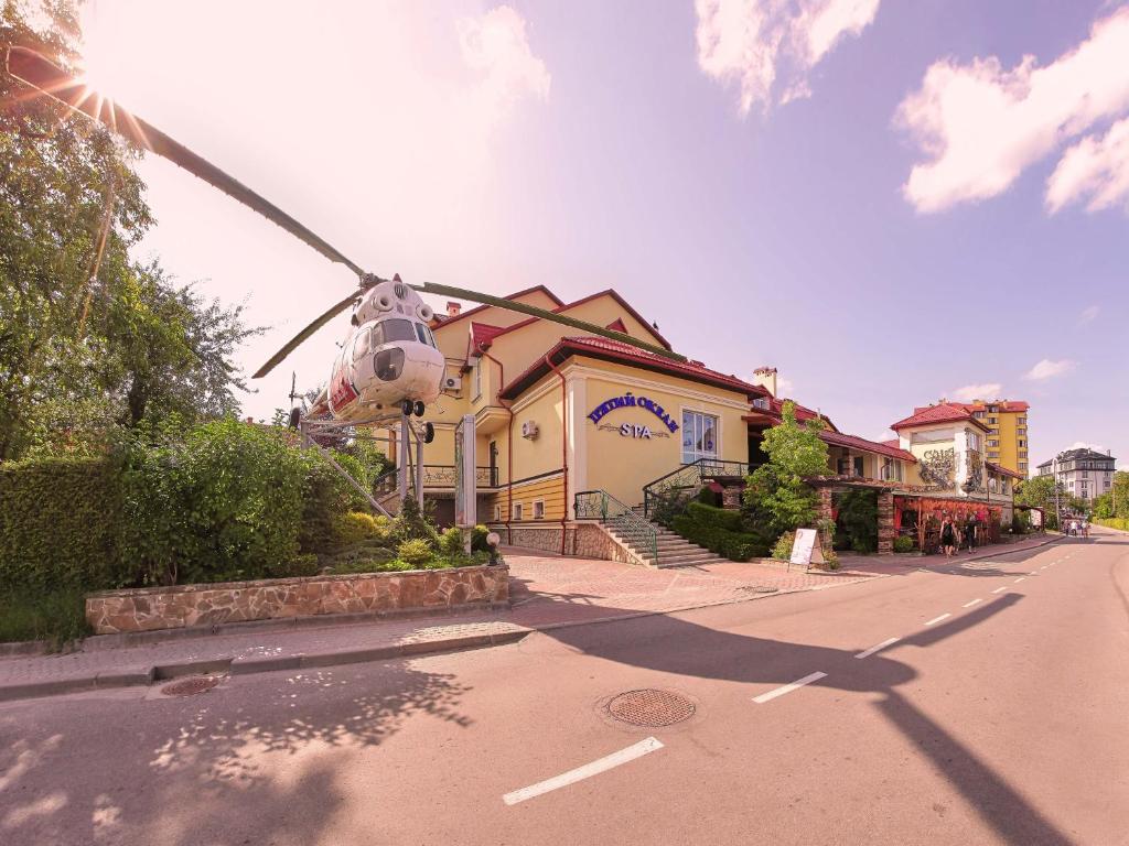 a helicopter is parked in front of a building at Fifth Ocean SPA Hotel in Truskavets