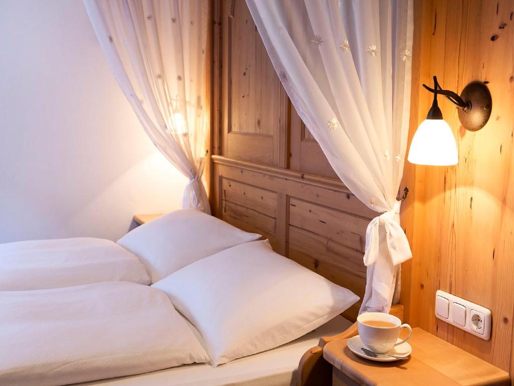 A bed or beds in a room at Hotel Auhof