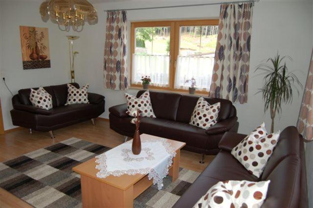 a living room with couches and a coffee table at Haus Gantioler in Mieders