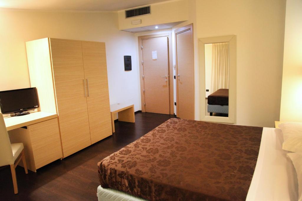 Postel nebo postele na pokoji v ubytování Hotel Sogni D'Oro Airport