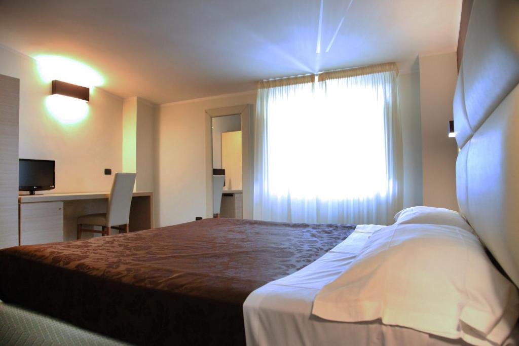 Postel nebo postele na pokoji v ubytování Hotel Sogni D'Oro Airport