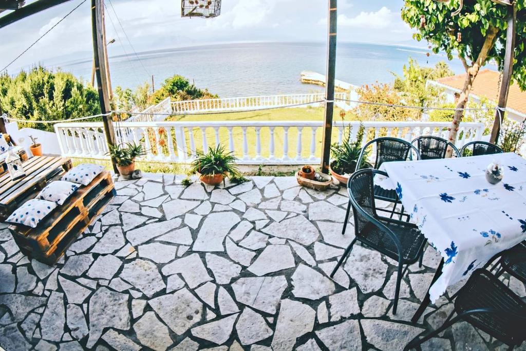 a patio with a table and chairs and the ocean at Villa Galanis by the sea in Niforeika