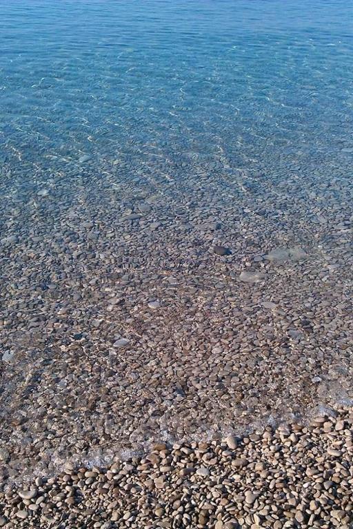 a group of rocks on the shore of the water at Apartment Quiet Getaway in Koromačno